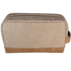 A brown canvas toiletry bag  and leather details, featuring a zipper closure and a brand logo embossed on the front.