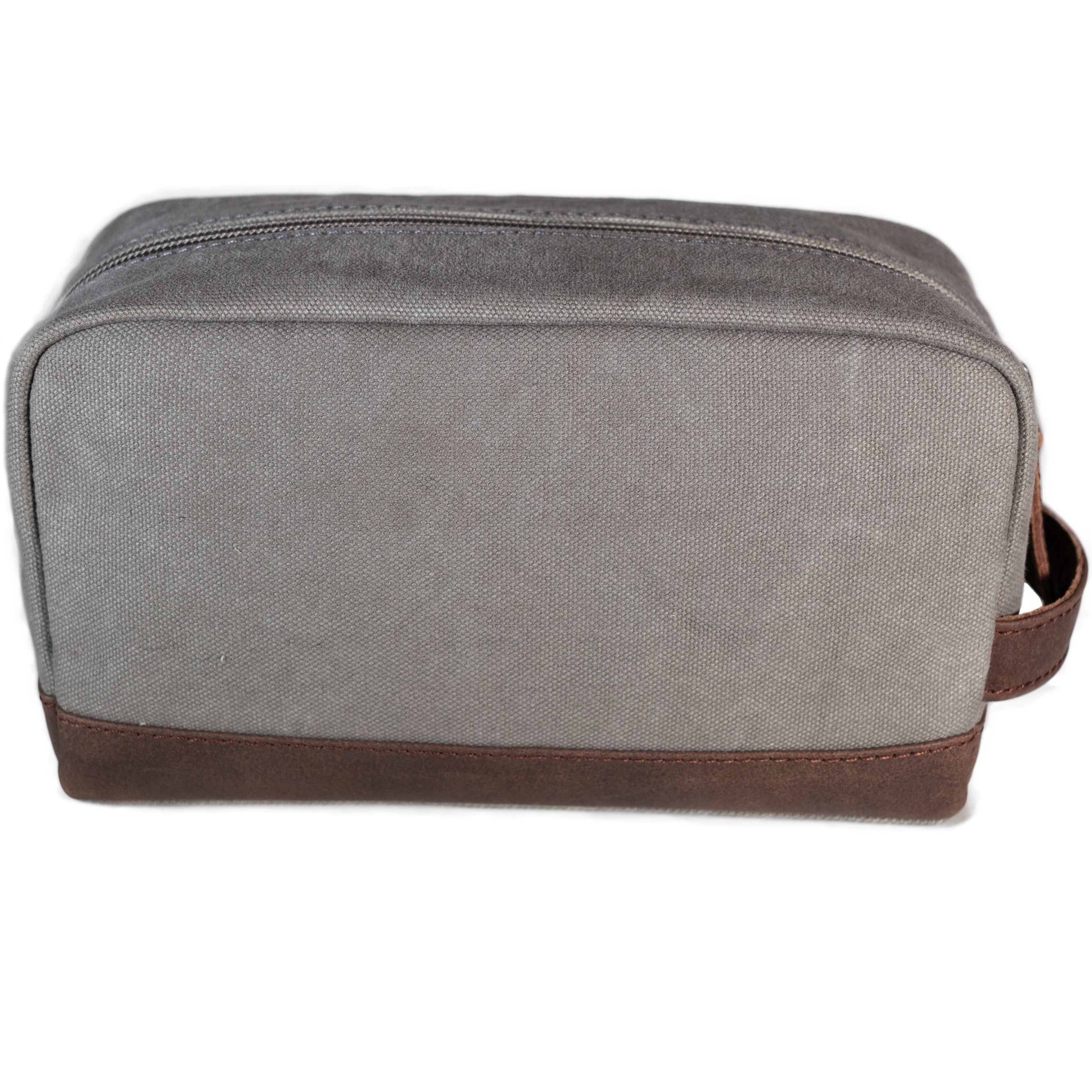 A grey canvas toiletry bag and brown leather details, featuring a zipper closure and a brand logo embossed on the front.